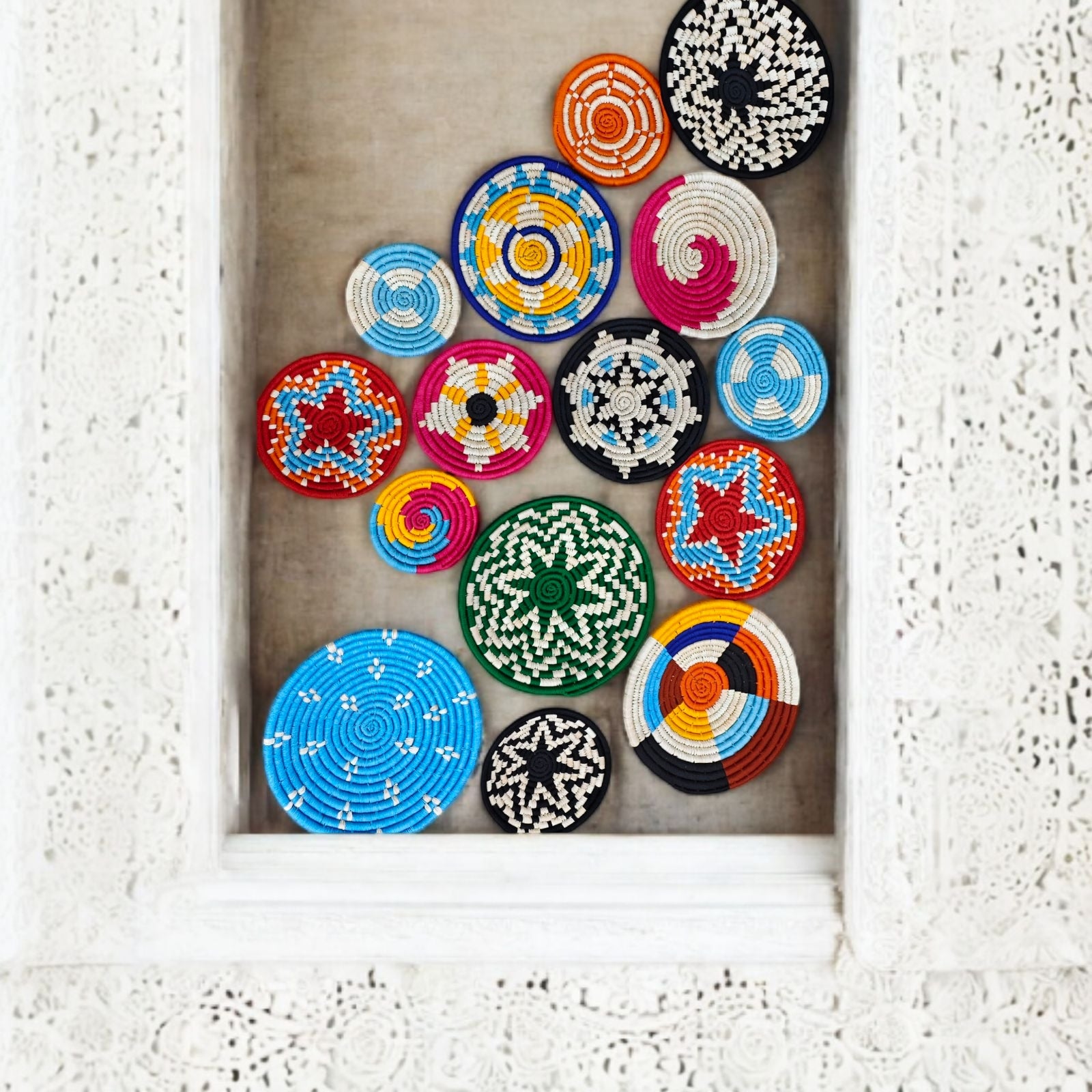 Colorful handmade Sabai grass woven wall plates in a decorative arrangement, perfect for Boho wall decor.